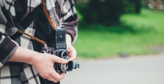 boy holding an old box camera