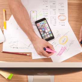 smartphone on a table with drawings